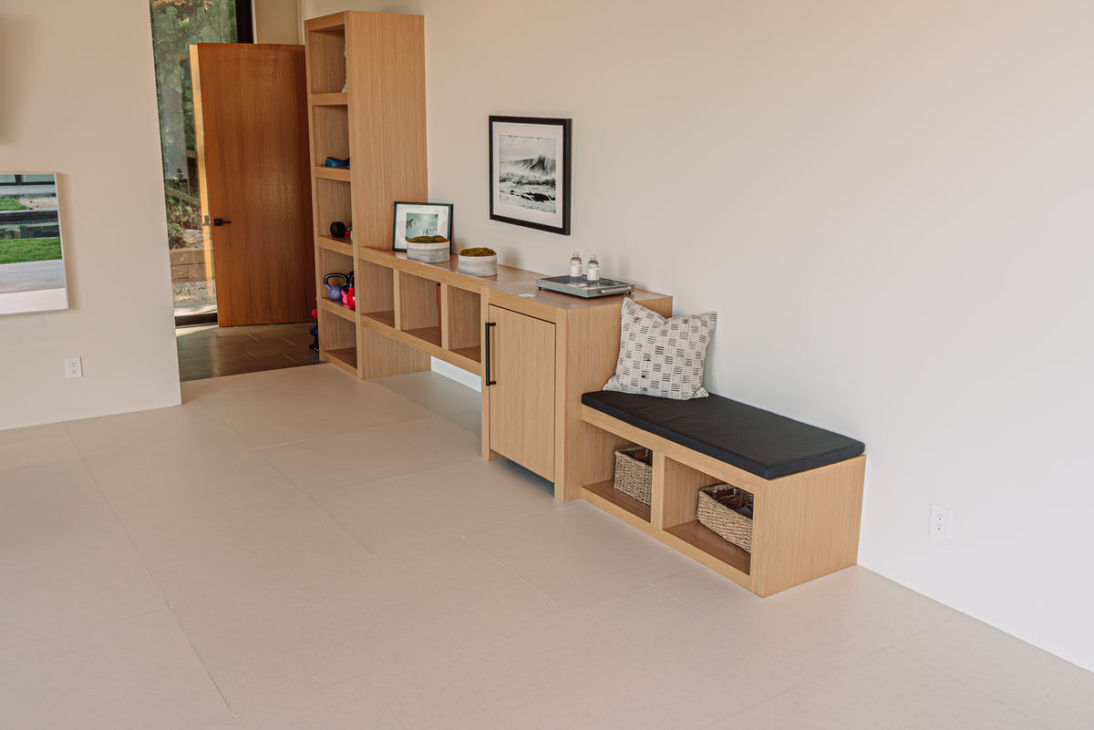 A bright room with built-in shelves and a soft floor fitted edge to edge