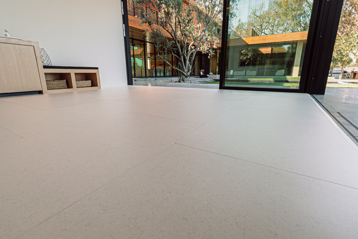 A finished room with a soft floor fitted from wall to wall and a view to the garden