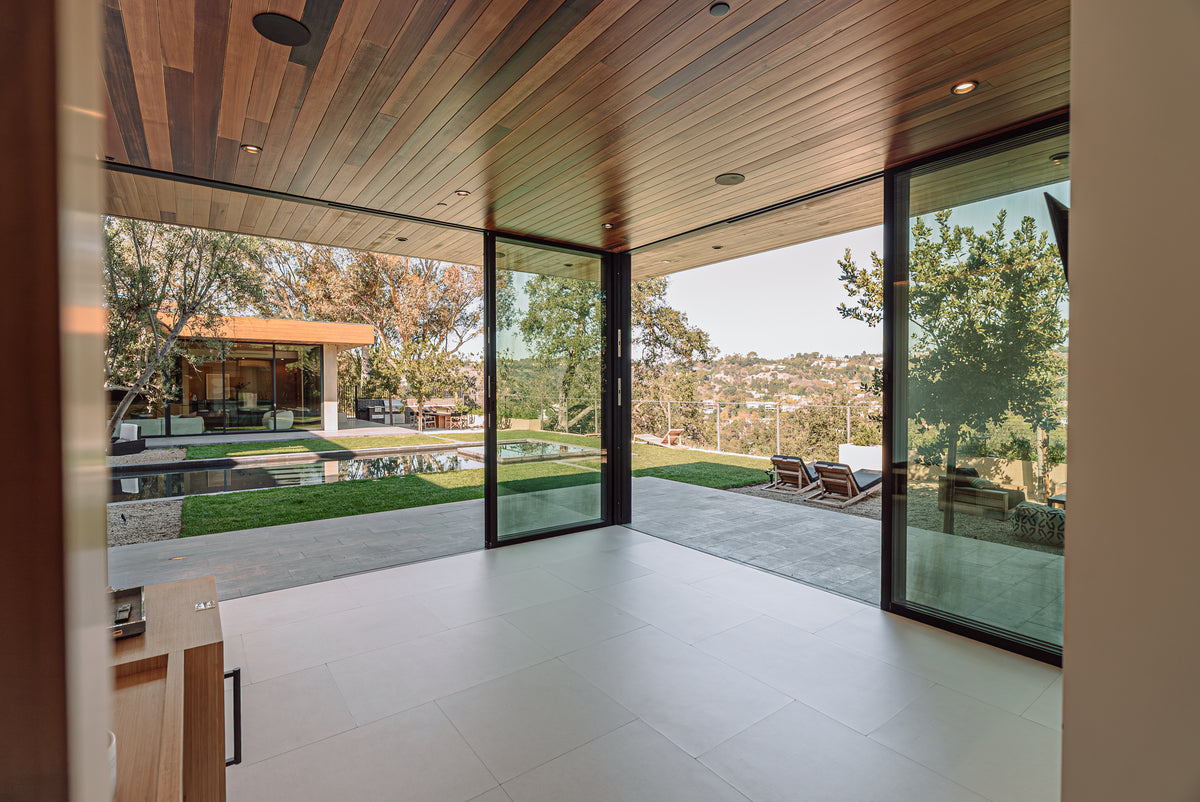 A soft floor fitted wall to wall, running out to tall glass doors and a garden