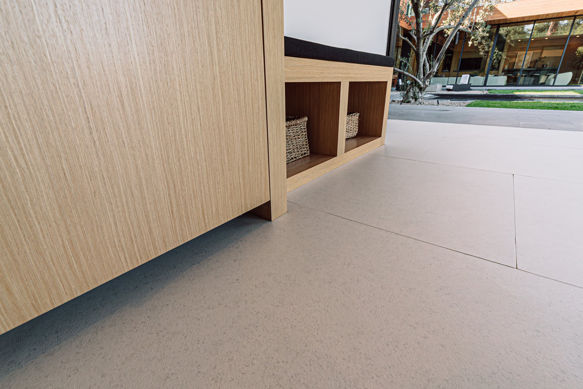 A soft floor fitted around built-in cabinets, opening to a patio
