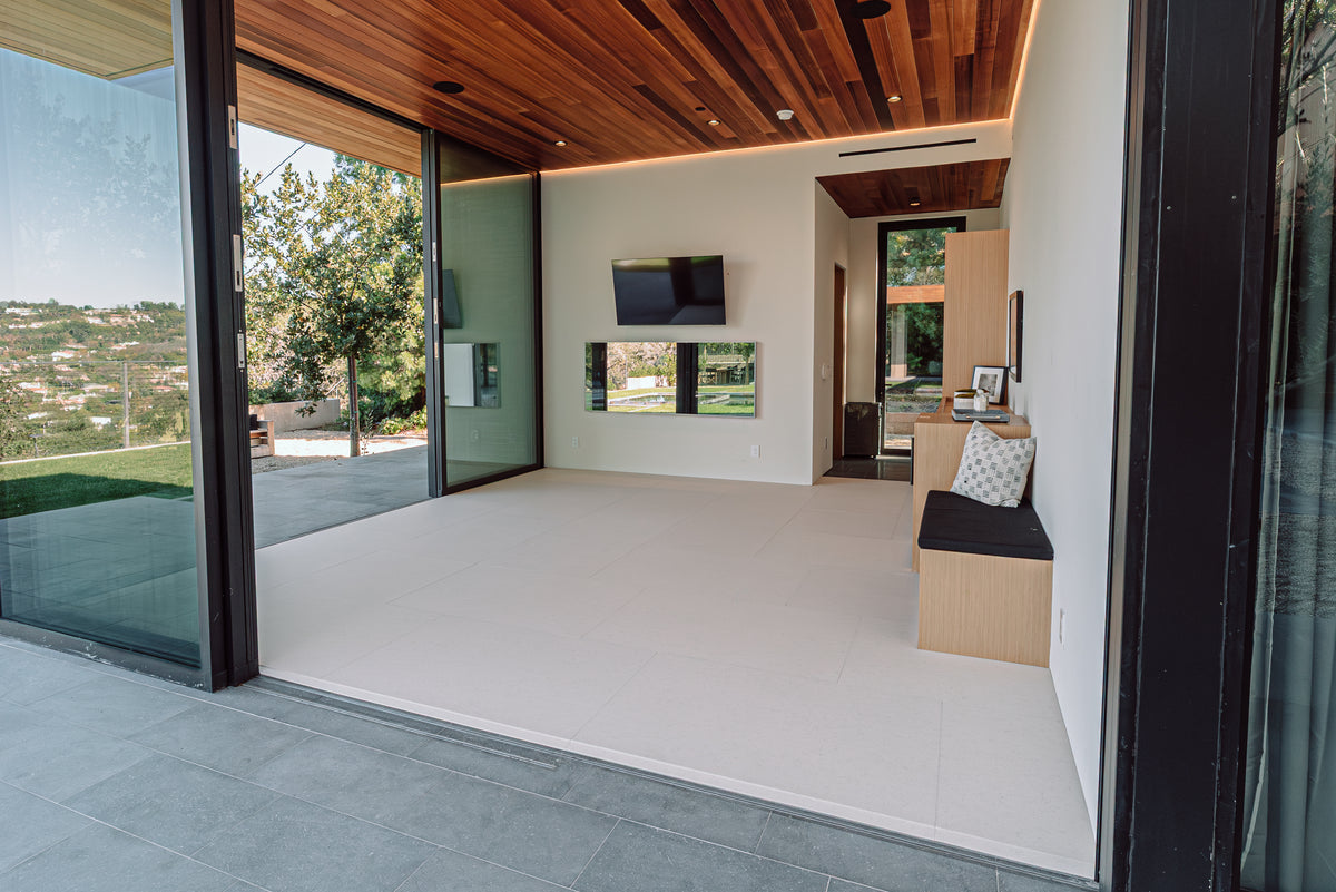 A finished room with a soft Matnificent floor fitted wall to wall, opening onto a patio through tall glass doors